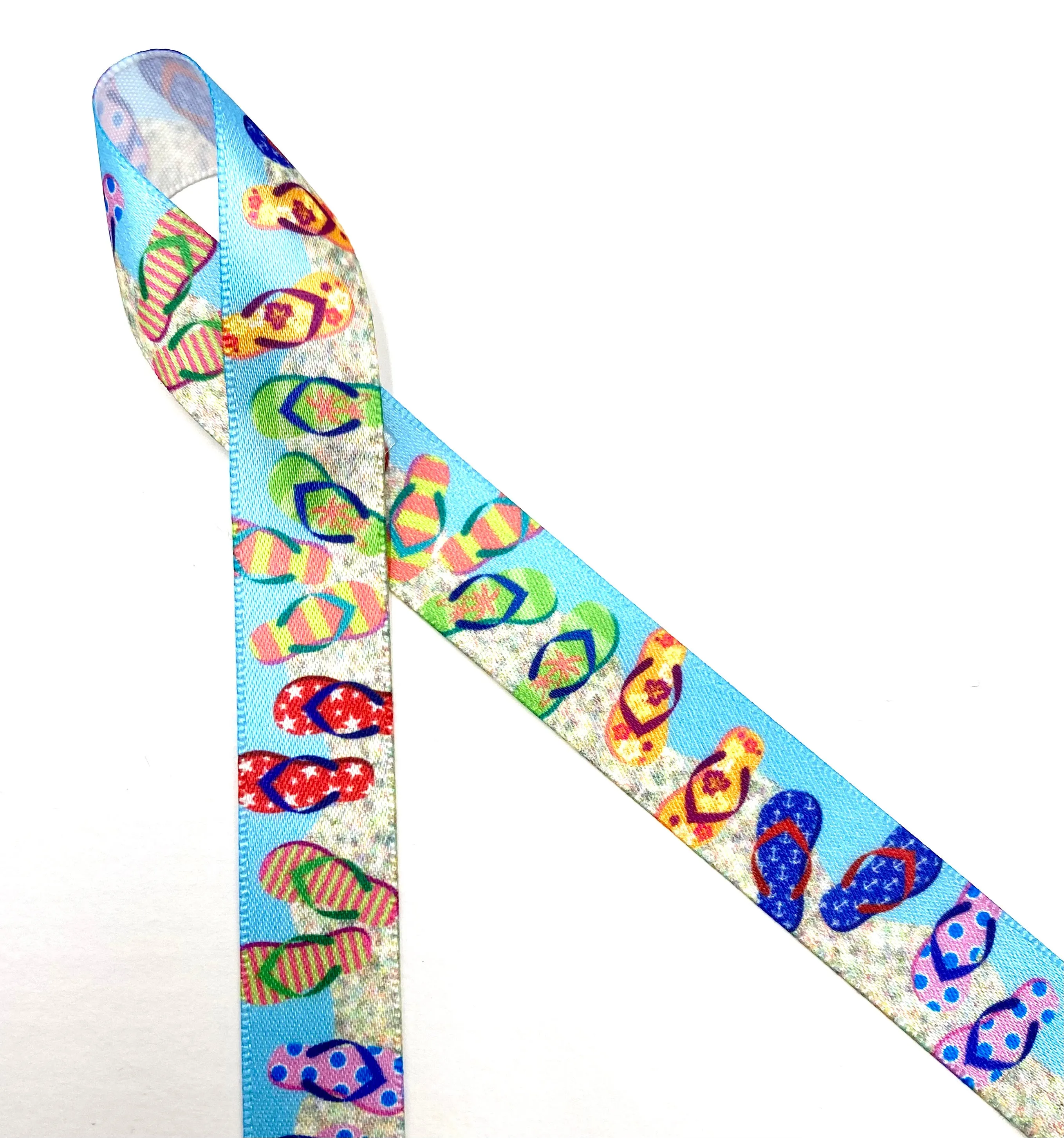 Flip Flop ribbon colorful flip flops in stripes, stars, and floral designs on a sand and blue background printed on  5/8" and 7/8" white single face satin